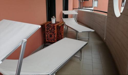 three empty benches in a room with a window at Gess Etna Home in Giarre