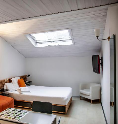 a bedroom with a bed and a skylight at Maria Salome in Burgos