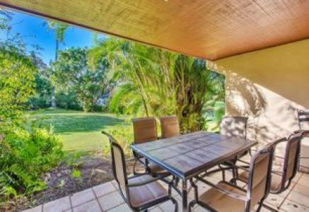 a patio with a table and chairs on a porch at KOA Resort 5D in Kihei