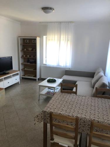 a living room with a couch and a table at Tihany Levendula Villa in Tihany