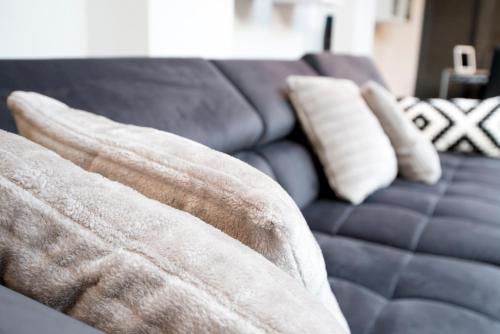 a couch with two pillows on top of it at White Lofty und White Studio in Düsseldorf