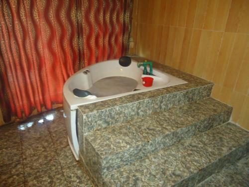 a cat sitting in a bath tub in a bathroom at Truong Xuan Ecology in Ha Giang