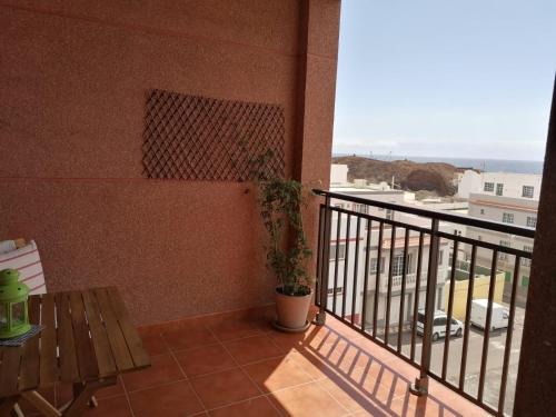 a balcony with a bench and a view of the ocean at Ecorestinga in La Restinga