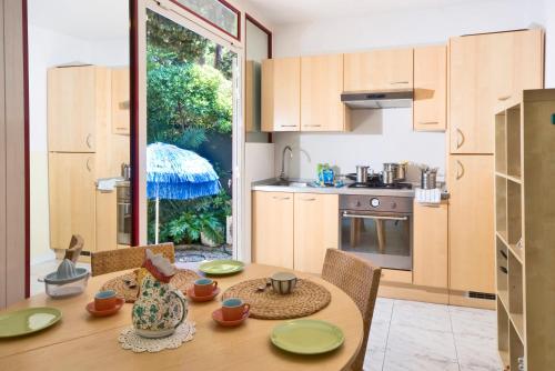 a kitchen with a wooden table and a dining room at Camere Da Aldo in centro Sirolo in Sirolo