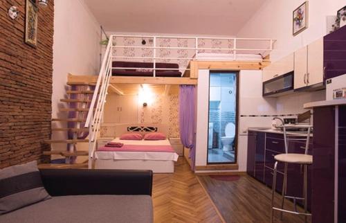 a small room with a bunk bed and a kitchen at Comfortable Flat in Central Tbilisi in Tbilisi City