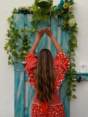 a girl is holding her hands up to a mirror at El Patio del Limonero in Écija