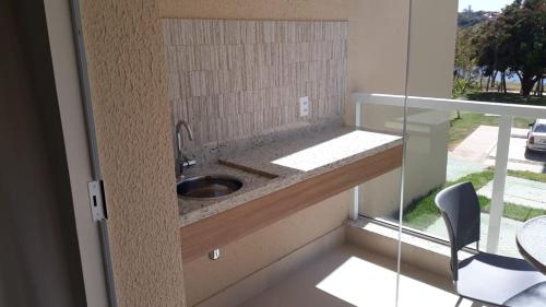 a bathroom with a sink and a window at Ilhas do Lago EcoResort in Caldas Novas