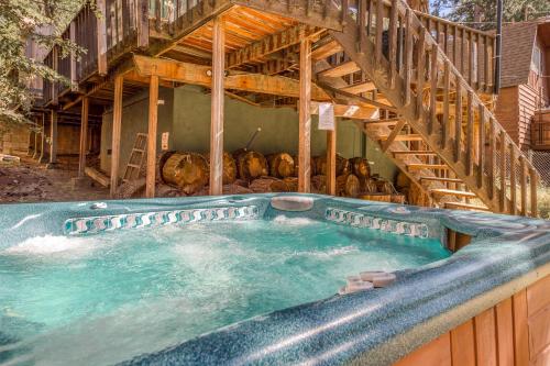a large swimming pool in a house with a staircase at Bear's Den in Idyllwild