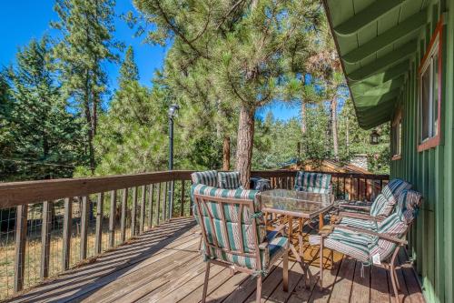 a patio with chairs and a table on a deck at Bear's Den in Idyllwild