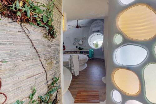a room with a wall with round mirrors and a room with a room at Seahorse @ Swan Villas in Placencia Village