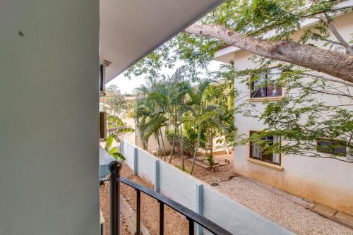 a view from the balcony of a house with a tree at Aquamarine 4 in Guanacaste
