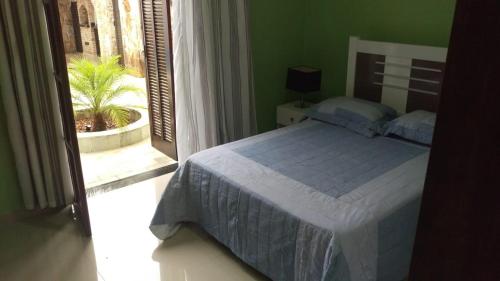 מיטה או מיטות בחדר ב-Meu Paraíso!