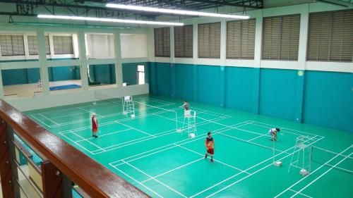 a group of people playing tennis on a tennis court at Lagoon view Family Suite in Pico De Loro Cove, Nasugbu in Nasugbu