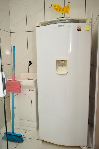 a white refrigerator in a kitchen next to a sink at Apart ZSS in Penha