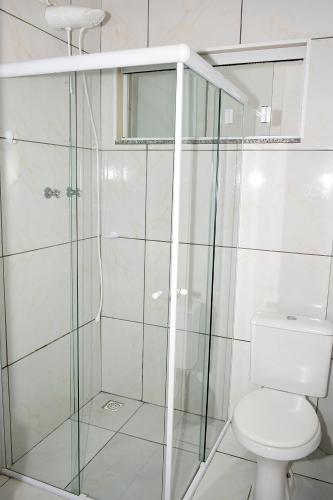a bathroom with a shower and a toilet at Apart ZSS in Penha