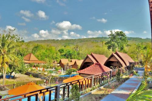 a view of a resort with orange umbrellas at Surya Chandra Beach Bungalow in Nusa Penida