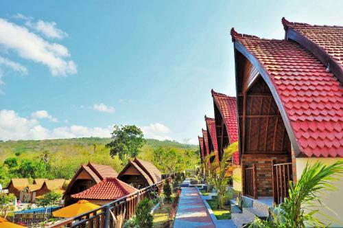 a row of houses with red roofs at Surya Chandra Beach Bungalow in Nusa Penida