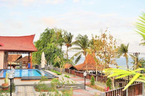 a view of a resort with a swimming pool at Surya Chandra Beach Bungalow in Nusa Penida