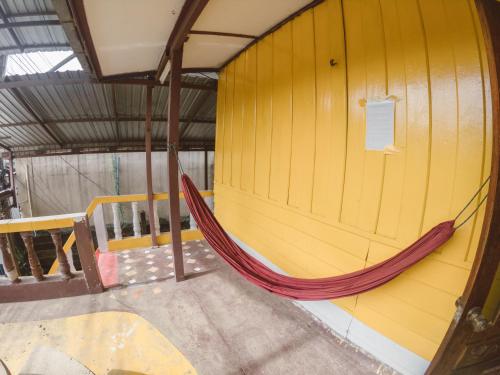 a hammock in a room with a wall at Pan's Place in Vang Vieng
