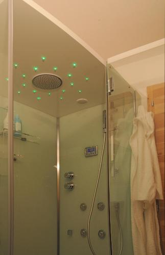 a bathroom with a shower with green lights on the ceiling at B&B Terre Di Bea in Pederobba