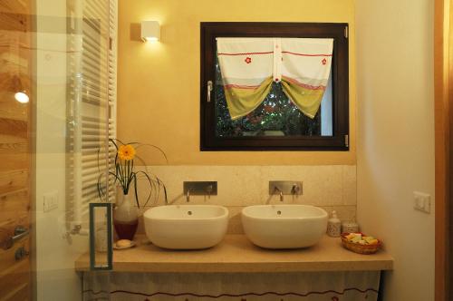 a bathroom with two white sinks on a counter at B&B Terre Di Bea in Pederobba