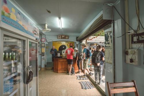a group of people standing in a store aisle at Pan's Place in Vang Vieng