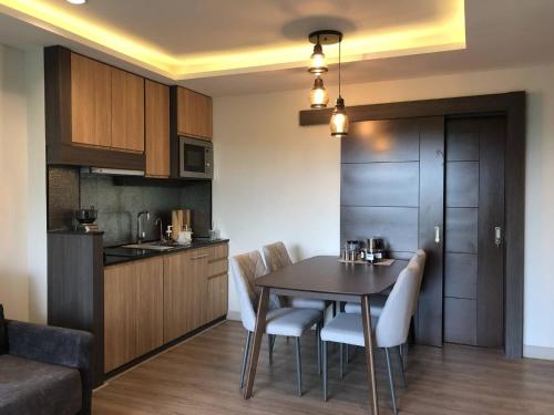 a kitchen and dining room with a table and chairs at Reiz - Private Residence in Chiang Mai