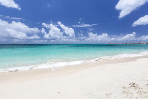 a beach with turquoise water and the ocean at White Sands Anguilla - Sea in Blowing Point Village