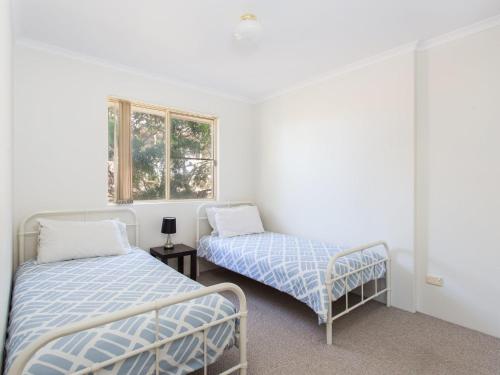 a bedroom with two beds and a window at Haven Waters 6 in Forster