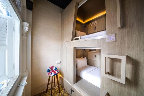um pequeno quarto com um beliche num quarto em CUBE Boutique Capsule Hotel at Kampong Glam em Singapura