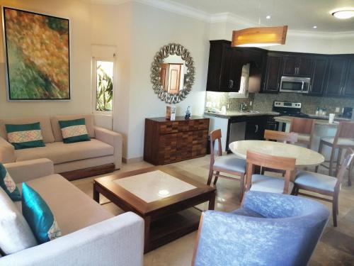 a living room with a couch and a table at Luxury Suites By Estrella del Mar in Mazatlán