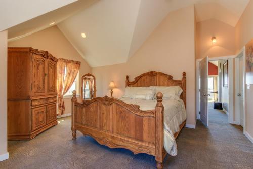 a bedroom with a large wooden bed and a dresser at Crystal Rose Home and Cottage in Lincoln City