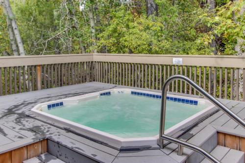 a hot tub on a deck with a fence at Bridgepoint Condo on Trail Creek in Ketchum