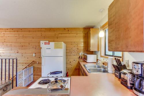 a kitchen with a white refrigerator and a sink at The Little Brown House MCA #705 in Manzanita