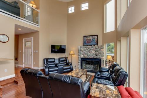 a living room with leather furniture and a fireplace at Lake House PlayLand in Lincoln City