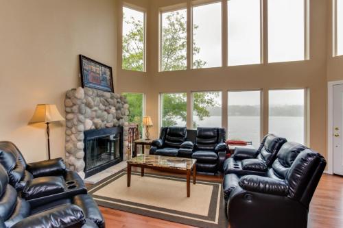 a living room with leather furniture and a fireplace at Lake House PlayLand in Lincoln City