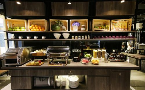a kitchen with a counter with food on it at CUBE Boutique Capsule Hotel at Chinatown in Singapore