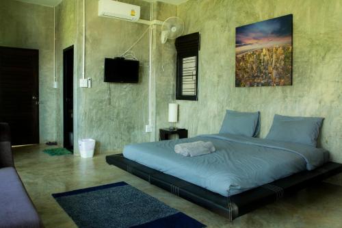 - une chambre dotée d'un grand lit avec des draps bleus dans l'établissement Phu Pha View Doi, à Samoeng