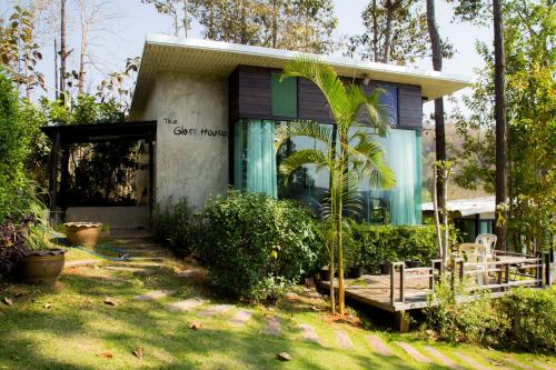 a house with a palm tree in front of it at Phu Pha View Doi in Samoeng