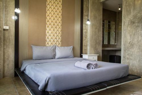 a bedroom with a large bed in a room at Phu Pha View Doi in Samoeng