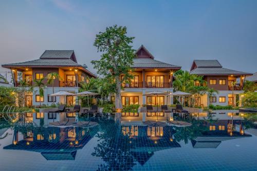 a resort with a pool in front of it at Lanna Deer Resort Chiang Mai in Chiang Mai