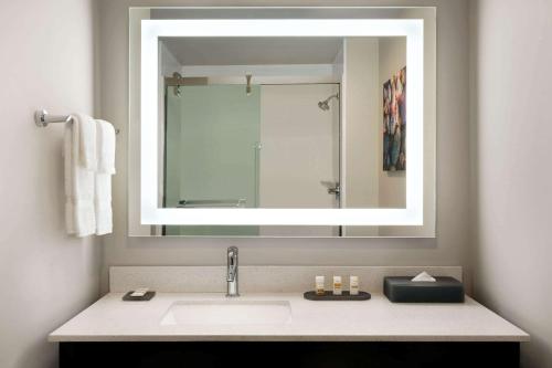 a bathroom with a sink and a mirror at La Quinta Inn & Suites by Wyndham Burlington in Burlington