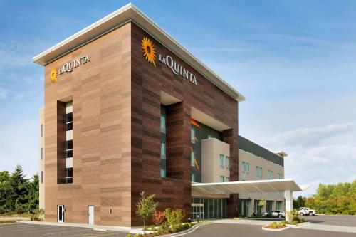 a rendering of a building with a sunflower on it at La Quinta Inn & Suites by Wyndham Burlington in Burlington