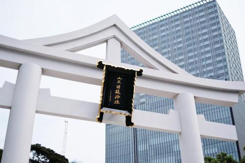a sign hanging on a white fence in front of a building at Best Western Hotel Fino Tokyo Akasaka in Tokyo