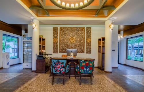 a dining room with a table and two chairs at Lanna Deer Resort Chiang Mai in Chiang Mai