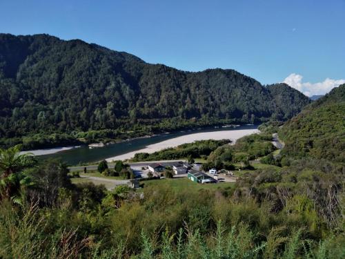 a view of a river from a hill with trees at Berlins cafe, bar and backpackers in Newton Flat