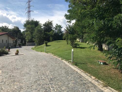 a cobblestone road leading to a field with a tower at B&B Oasi Vetoio in LʼAquila
