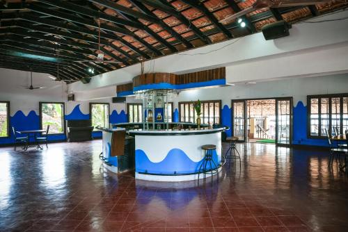 a large room with a bar in the middle of it at Baia Do Sol - Beach boutique in Baga
