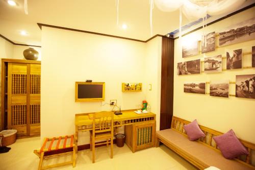 a room with a desk and a computer in it at Hoi An Pho Library Hotel in Hoi An