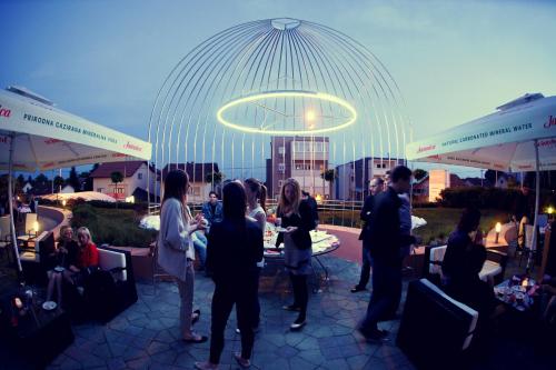 a group of people standing in a patio with a dome at Hotel Phoenix in Sesvete